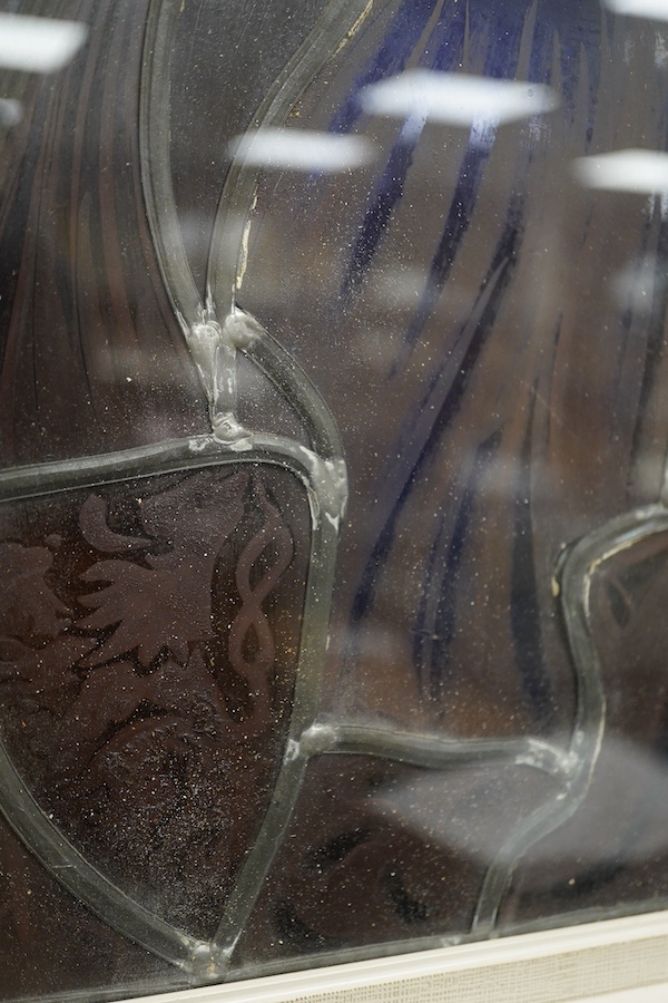 A stained and leaded glass panel of a romantic couple in front of a cathedral, 48cm high